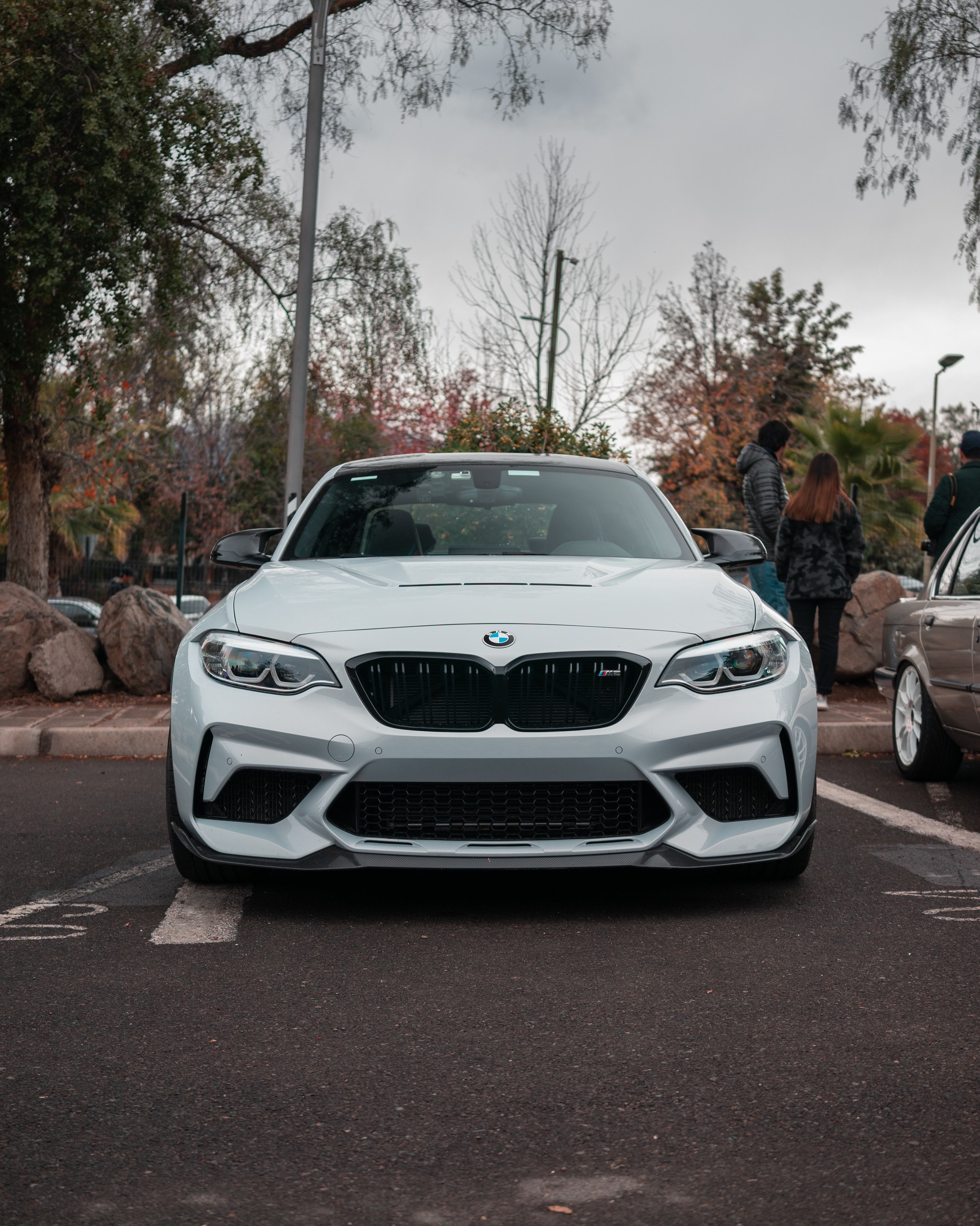 BMW F87 M2 in Hockenheim Silver Metallic color parked on the street showcasing its sleek body design and sporty stance