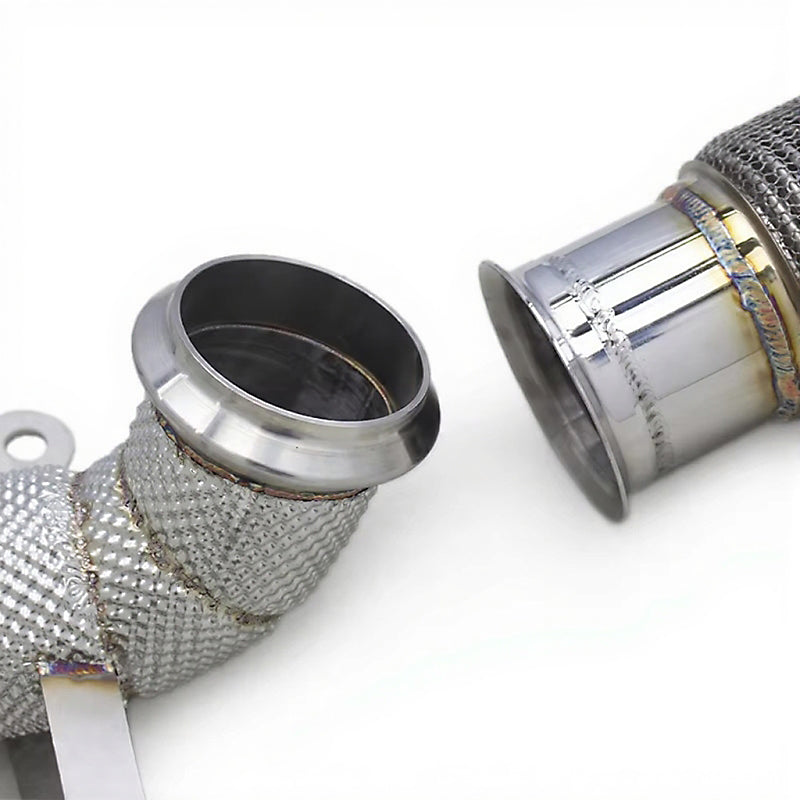Close-up of metal exhaust pipes with mesh wrapping on a white background